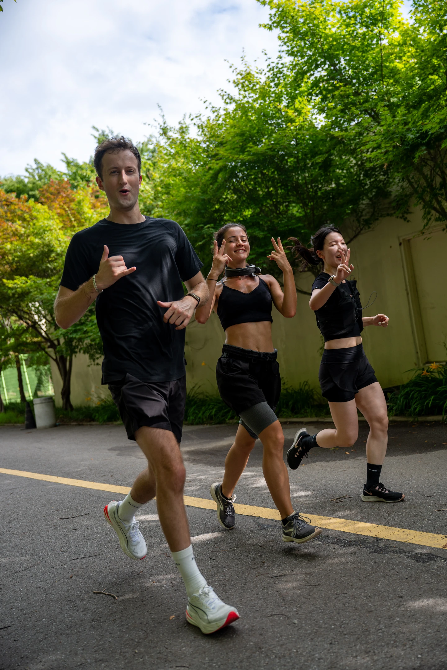 Three RUN N'ICE members smiling and running together