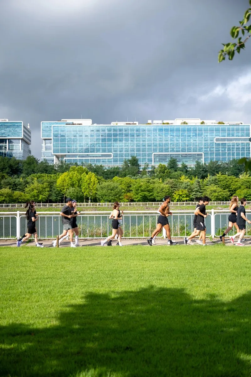 RUN N'ICE members running together beside the water